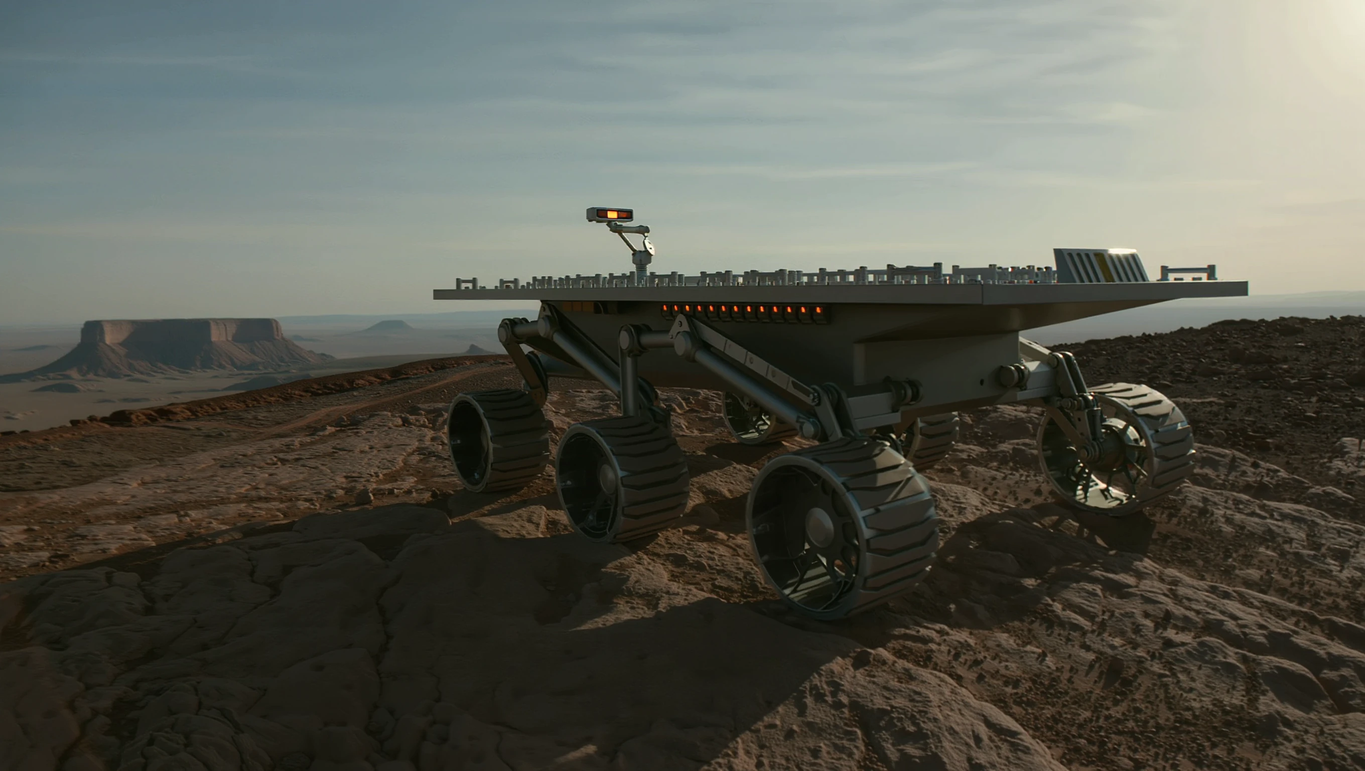 The analog rover on a rocky ridge, instrument deck visible.